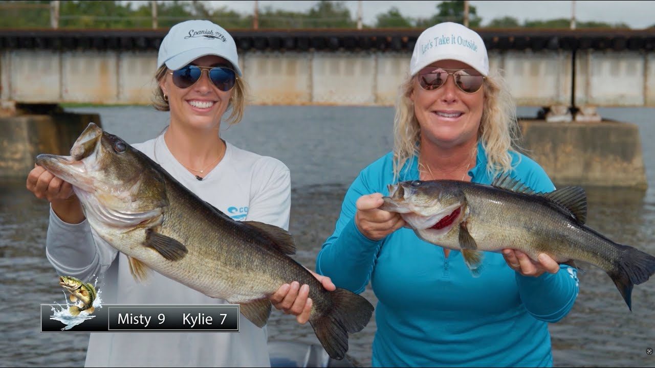 Anglers holding Florida largemouth bass on Putnam County water